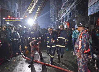 Bangladeshi leader says a shopping mall that caught fire had no emergency exits. Death toll climbs