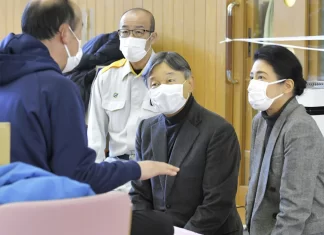 Japanese emperor and empress visit towns hit by Jan. 1 quake and console thousands of homeless