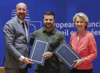 Ukraine’s leader urges EU leaders to make good on their arms promises as a security pact is signed