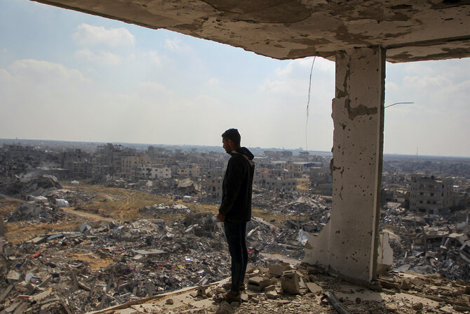 Palestinian man views the rubble of buildings destroyed during the Israeli offensive, amid a ceasefire between Israel and Hamas, in Rafah in the southern Gaza Strip