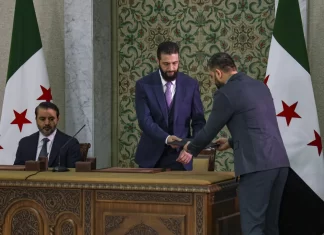 Syrian leader signs constitution that puts the country under an Islamist group’s rule for 5 years