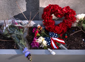 Suspect in shooting of National Guard members faces murder charge as US halts all asylum decisions