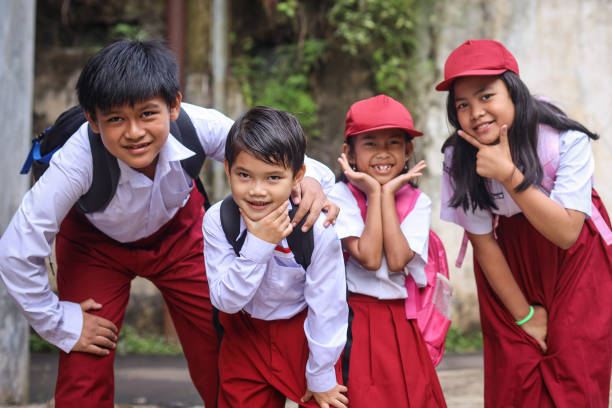 Portrait Of Diverse Elementary Student In Uniform Smiling And Pose At Camera
