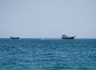 Tanker Hit by Projectile Off Oman Amid Rising US-Iran Tensions in Strait of Hormuz